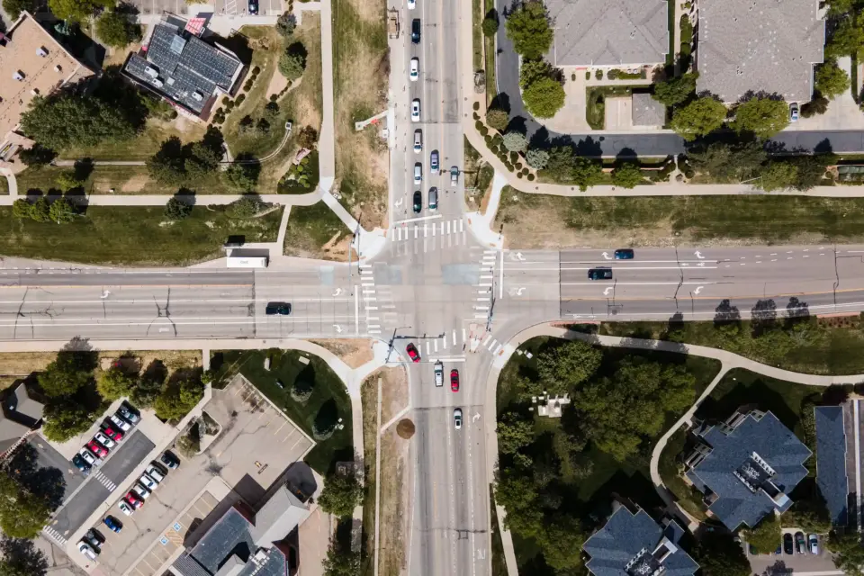 An aerial view of a road intersection where the traffic signal cabinets use PolyFrost to keep cool.