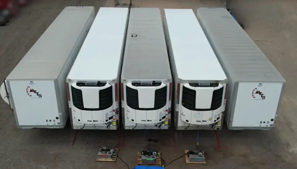 Aerial view of refrigerated trailers comparing Polyfrost coated roofs and bare aluminum roofs